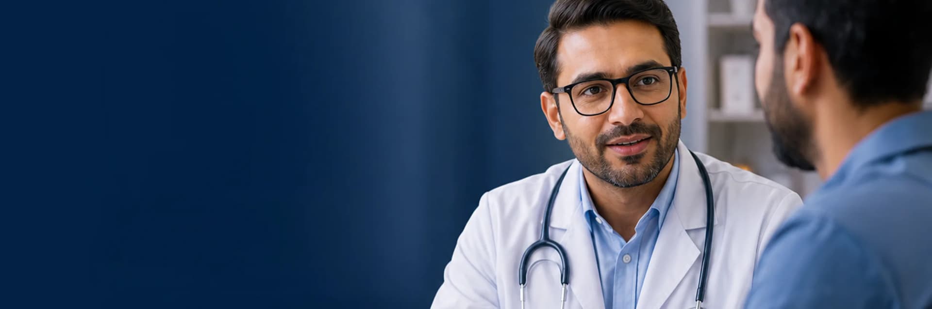 A doctor in conversation with a patient across a consulting-room desk